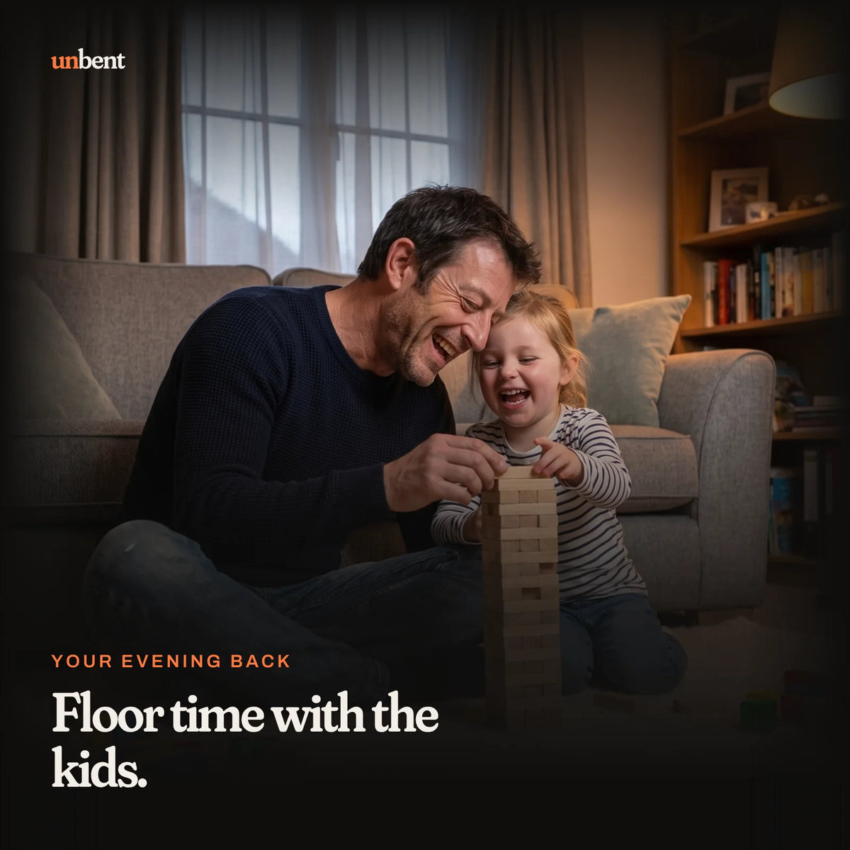 A dad on the living room floor building a block tower with his daughter